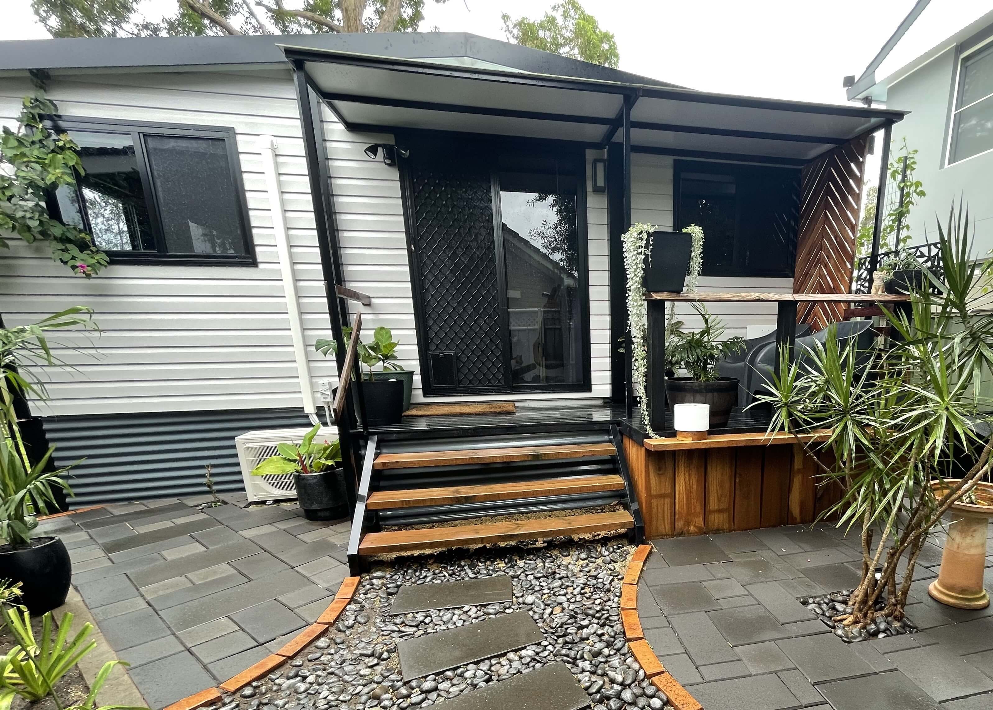 VanHomes Front Entrance: Featuring stairs leading to the front door, with large windows for natural light.